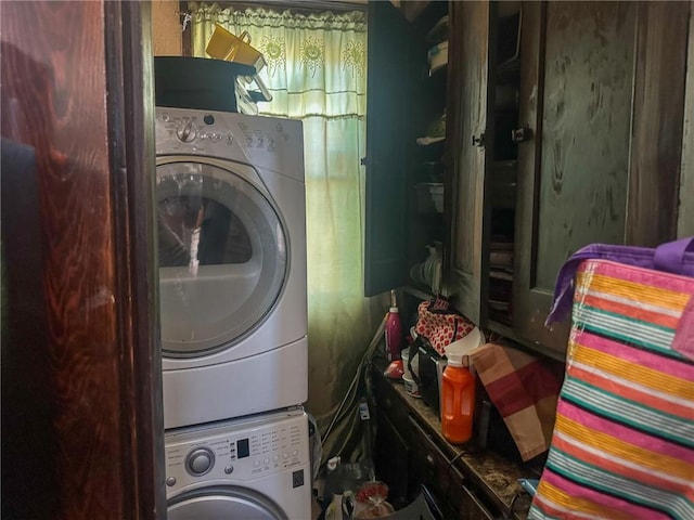 washroom featuring stacked washing maching and dryer