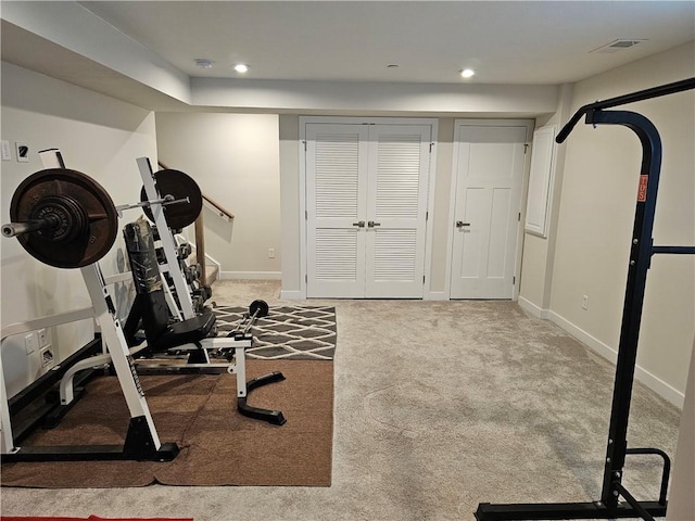 exercise room featuring light carpet