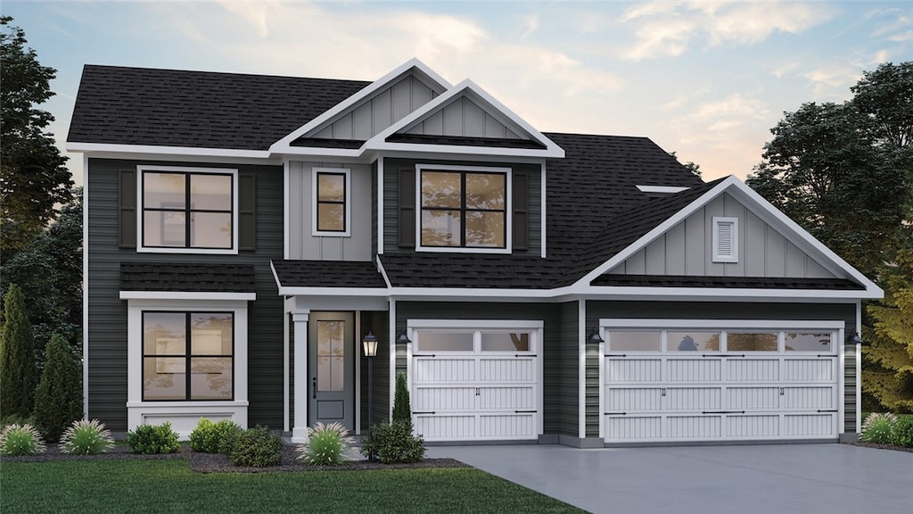 view of front of home with a yard and a garage