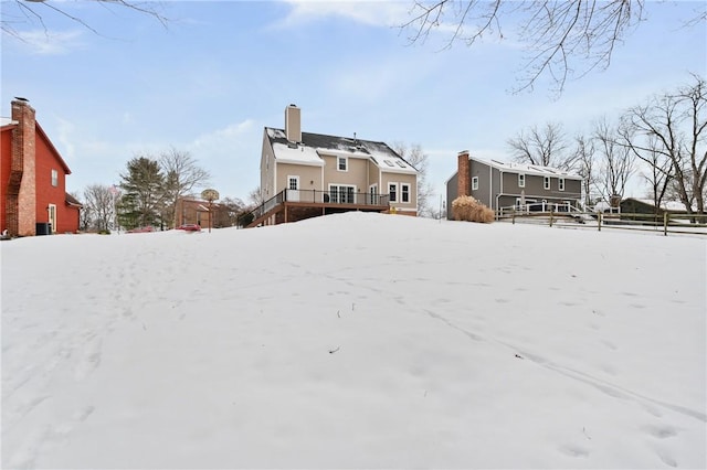 yard covered in snow with a wooden deck