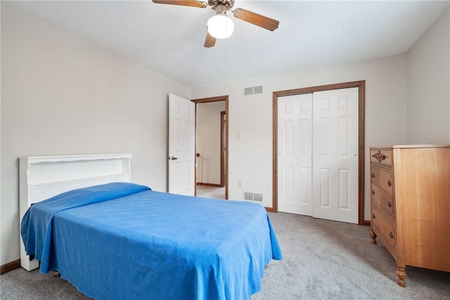 carpeted bedroom with ceiling fan and a closet