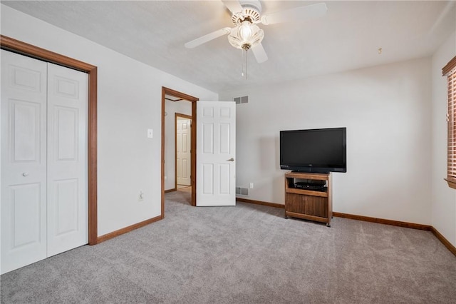 unfurnished bedroom with light carpet, ceiling fan, and a closet