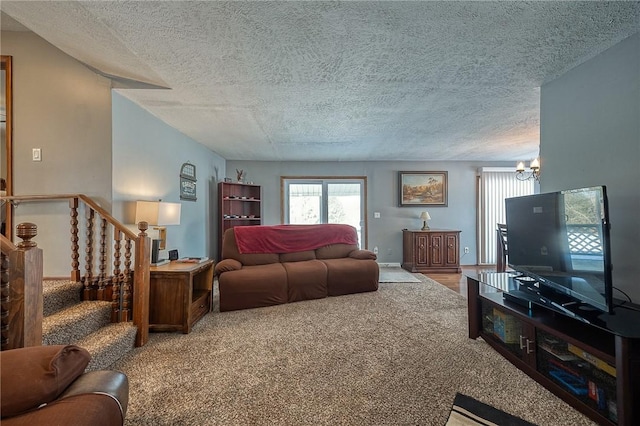 carpeted living room with an inviting chandelier and a textured ceiling