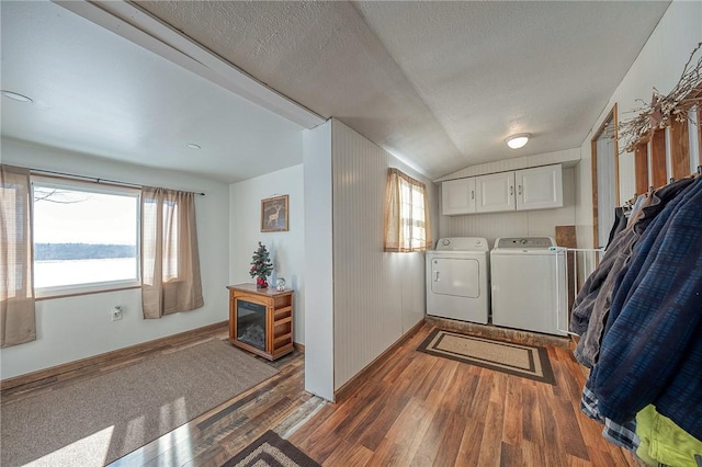 laundry area with cabinets, separate washer and dryer, dark hardwood / wood-style floors, and plenty of natural light