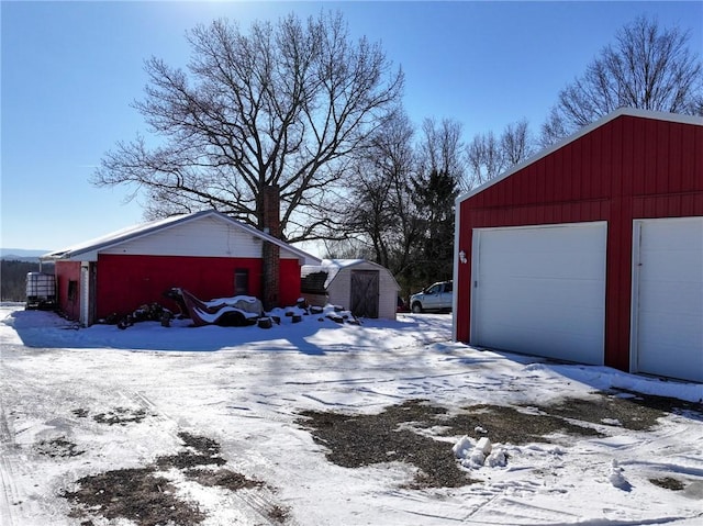 exterior space featuring a garage and a storage shed