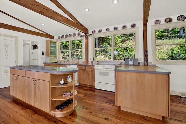 kitchen with white appliances, wood-type flooring, a center island, and lofted ceiling with beams