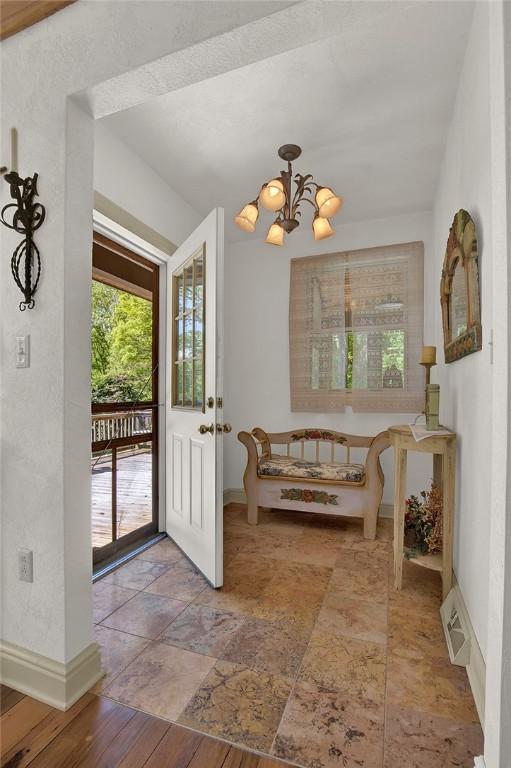 254 Light Ln, Cook Twp, PA 15658 - foyer featuring a chandelier and stone tile flooring