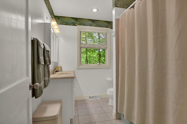 bathroom featuring vanity, toilet, and tile patterned flooring