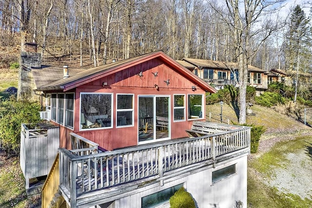 back of property with cooling unit and a sunroom