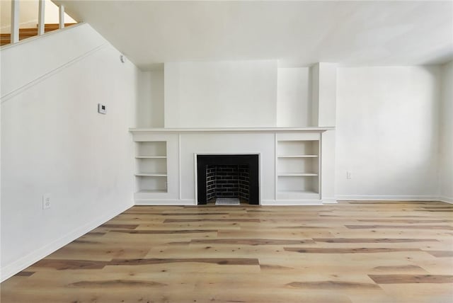 unfurnished living room featuring wood-type flooring