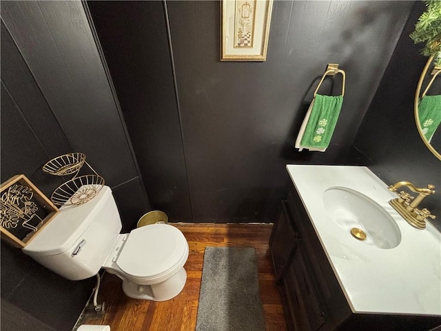 bathroom with vanity, hardwood / wood-style floors, and toilet