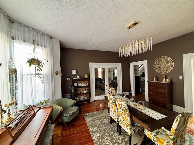 dining area featuring dark hardwood / wood-style flooring and a textured ceiling