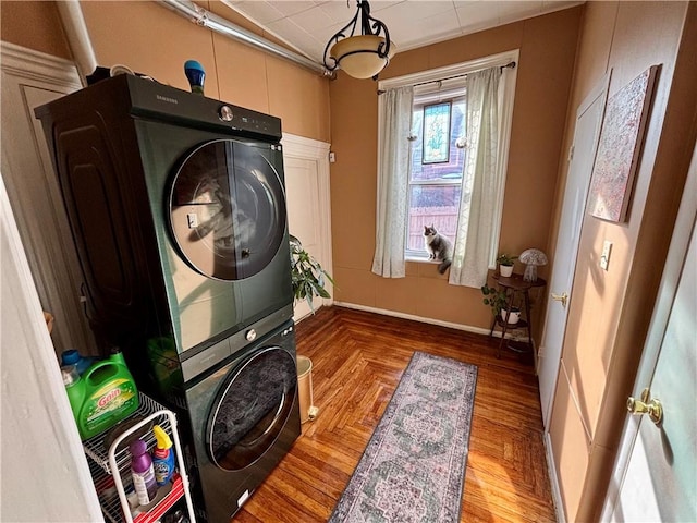 washroom featuring hardwood / wood-style floors and stacked washer and clothes dryer