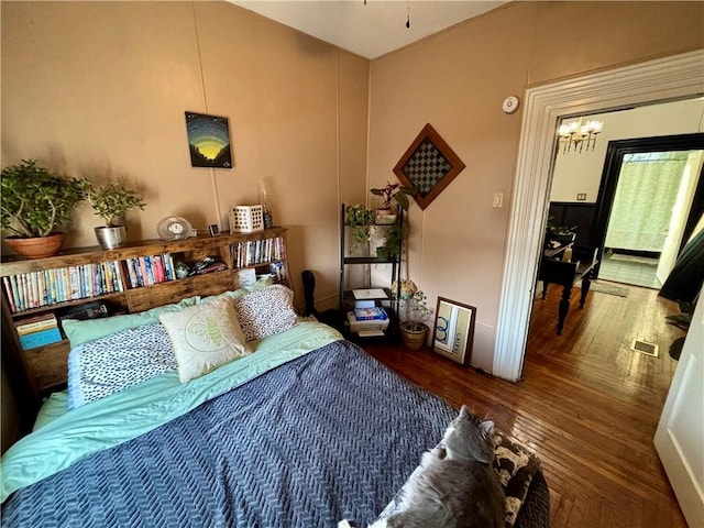 bedroom with dark wood-type flooring