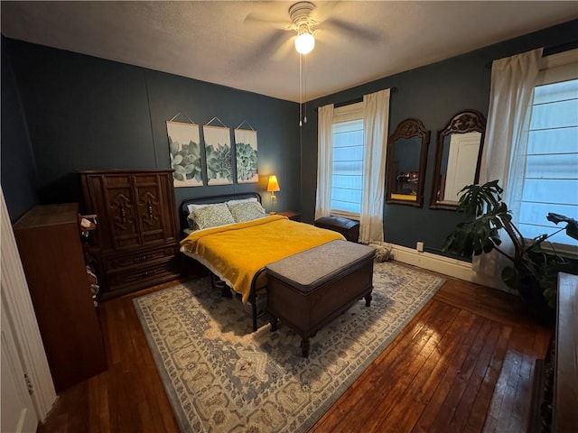 bedroom with dark hardwood / wood-style floors and ceiling fan