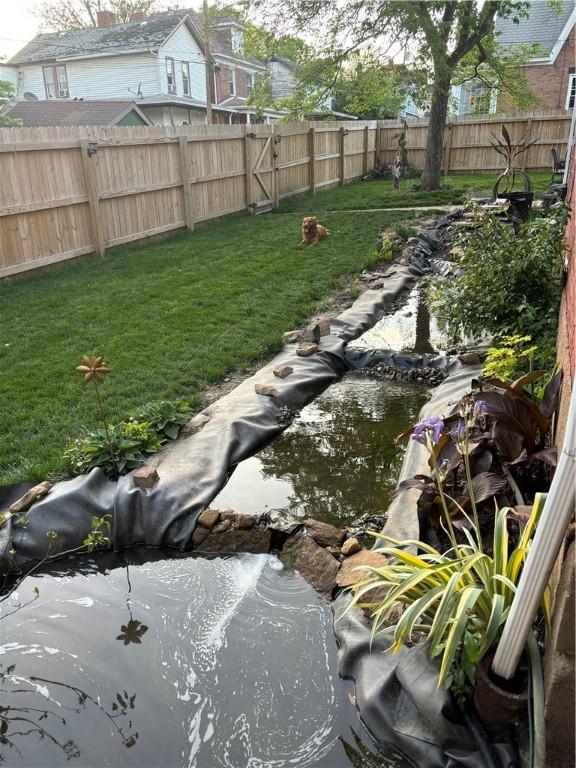 view of yard featuring a small pond