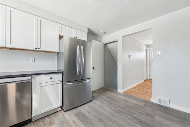 kitchen featuring white cabinetry, stainless steel appliances, and light hardwood / wood-style floors