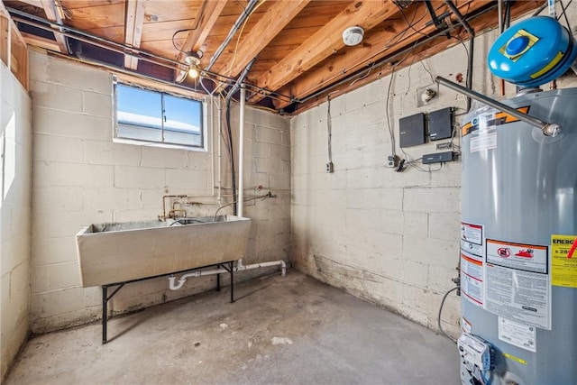 basement featuring sink and water heater