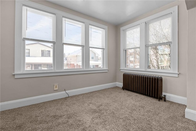 carpeted spare room with radiator heating unit