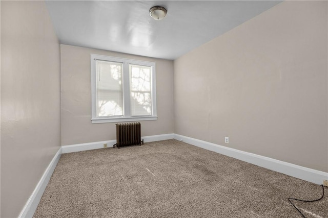 carpeted spare room featuring radiator heating unit