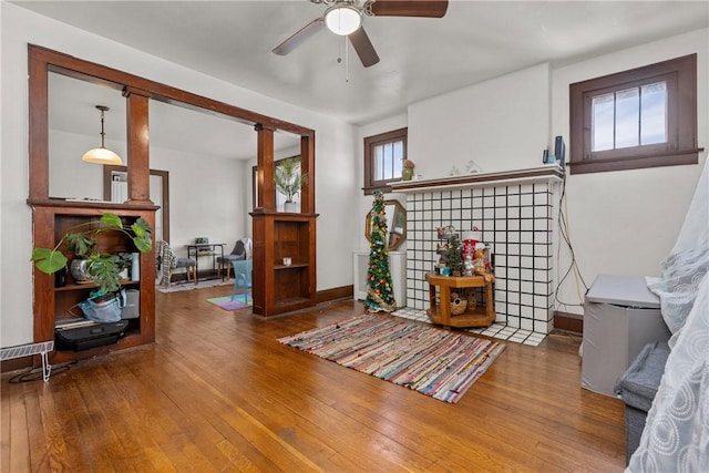 living area featuring hardwood / wood-style flooring, plenty of natural light, and ceiling fan