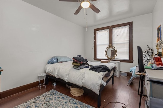 bedroom with dark wood-type flooring and ceiling fan