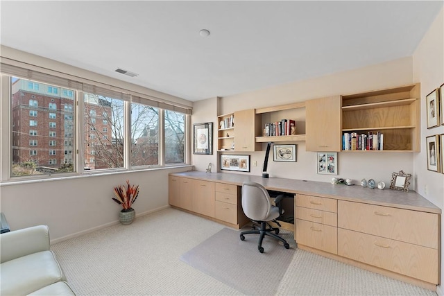 carpeted office with built in desk