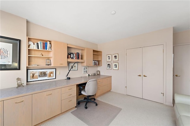 office space featuring light carpet and built in desk