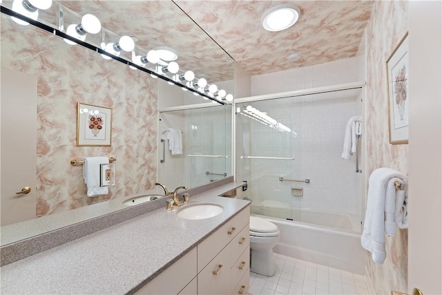 full bathroom with vanity, tile patterned floors, shower / bath combination with glass door, and toilet