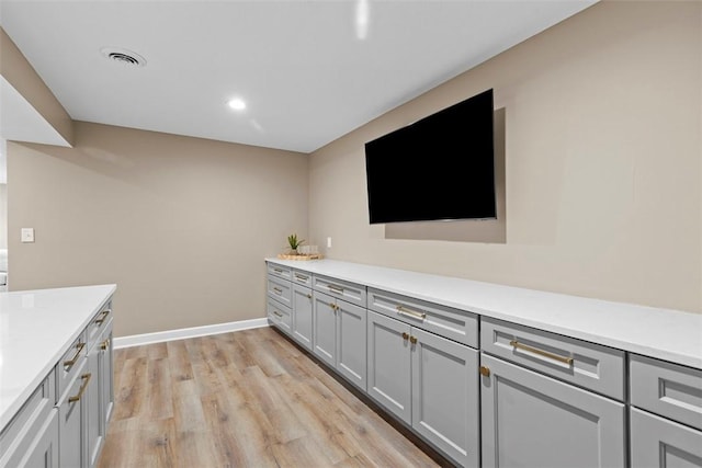 kitchen featuring light hardwood / wood-style floors and gray cabinetry