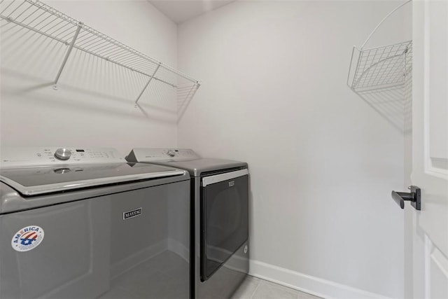 laundry room with light tile patterned floors and washing machine and dryer