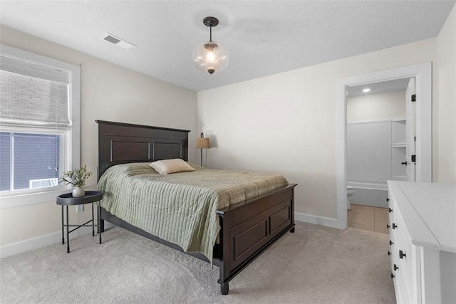 carpeted bedroom with ensuite bath