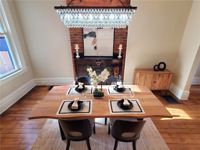 dining space featuring an inviting chandelier and hardwood / wood-style floors