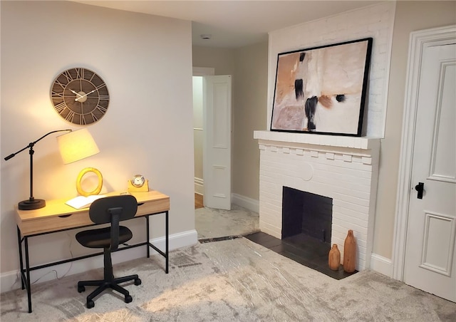 office area with carpet flooring and a brick fireplace