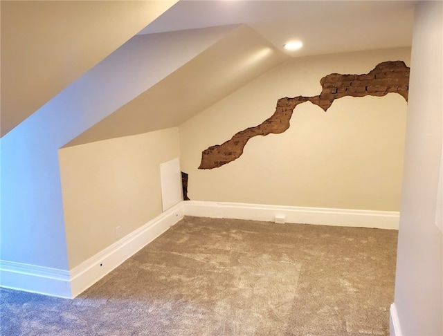 additional living space with lofted ceiling and carpet flooring