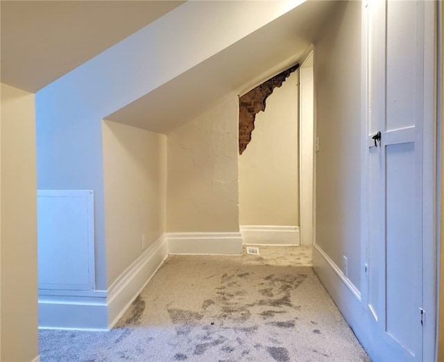 bonus room with lofted ceiling and carpet