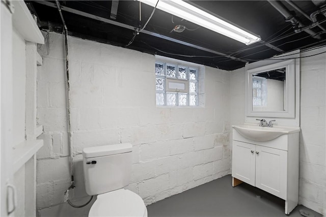 bathroom featuring vanity, concrete floors, and toilet