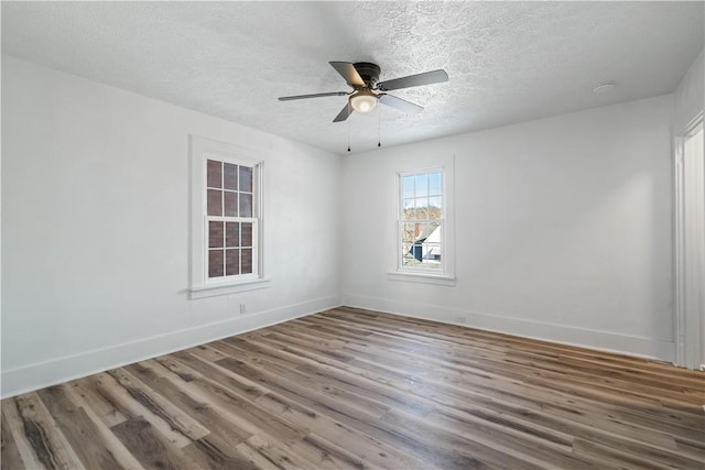 unfurnished room featuring ceiling fan, wood-type flooring, and a textured ceiling