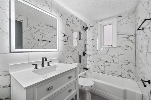 full bathroom with tile walls, vanity, a textured ceiling, toilet, and tiled shower / bath