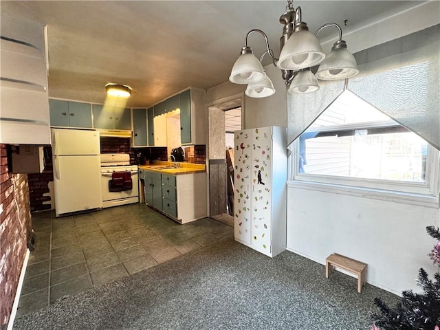 kitchen with sink, butcher block countertops, pendant lighting, white appliances, and brick wall