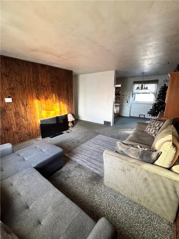 carpeted living room featuring wooden walls