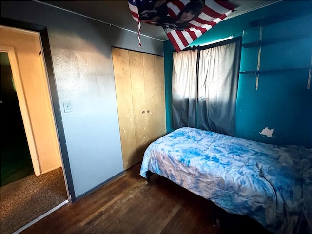 bedroom with dark hardwood / wood-style flooring