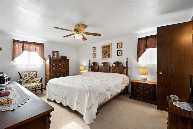 bedroom featuring ceiling fan and light carpet