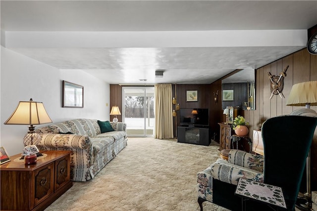 living room with light carpet and wood walls