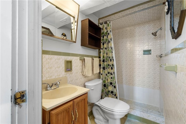 full bath with tile walls, toilet, vanity, and a shower stall