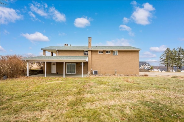 back of house featuring a lawn, a patio area, and cooling unit