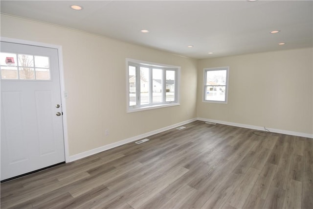 entryway featuring crown molding and hardwood / wood-style floors