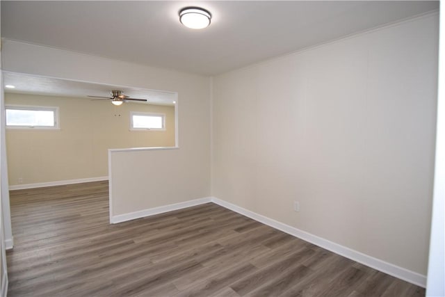 unfurnished room featuring dark hardwood / wood-style flooring, a wealth of natural light, and ceiling fan