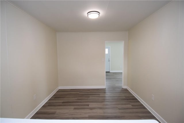 unfurnished room with dark hardwood / wood-style flooring