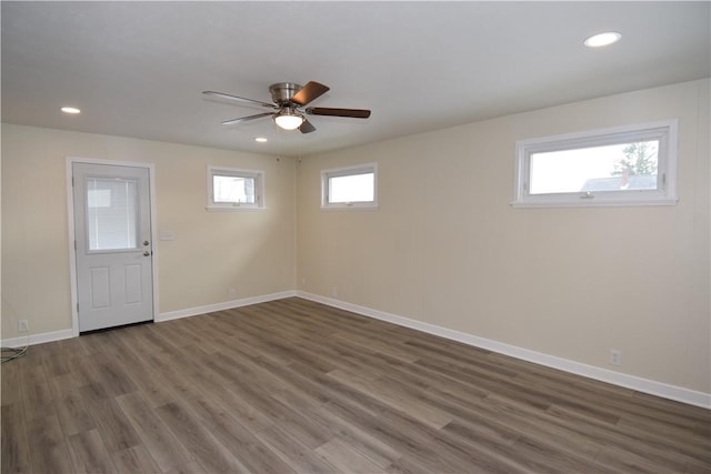 interior space featuring a wealth of natural light, dark hardwood / wood-style floors, and ceiling fan